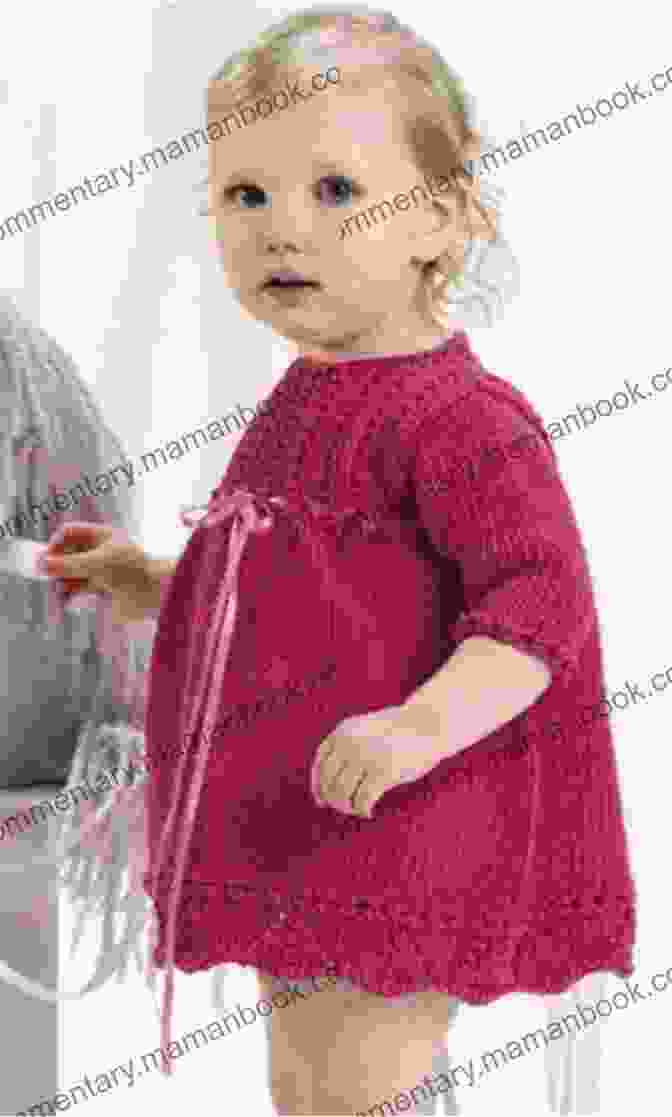 A Baby Toddler Wearing A Knitted Dress With A Cute Appliqué On The Front. Baby/Toddler Dress Knitting Pattern